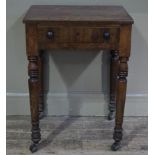 A 19th century mahogany table with frieze drawer on turned legs and castors