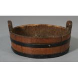 An oak and metal bound two handled coopered tub,