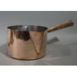 A Victorian double lipped copper saucepan with tapered cylindrical handle,
