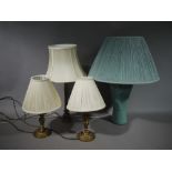 A modern green pottery baluster lamp with pleated shade;