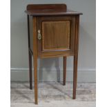 An Edwardian mahogany and satinwood banded pot cupboard having a short raised back and indented