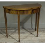 A mahogany and rosewood banded demi-lune card table the fold over top lined with baize and on