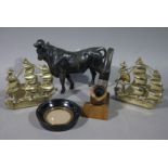 A bronzed white metal figure of a bull, a pair of pierced brass Victory bookends,