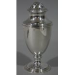 A silver sugar castor with rounded pierced top, baluster body and circular foot, 15cm high,