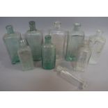 Four clear glass medicine bottles moulded with a Tea Spoon scale, 12.