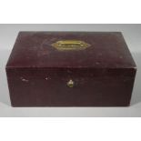 An Edwardian burgundy leather travelling box with inset brass carrying handle inscribed TAB from RB