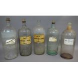 Five large pharmacy bottles, cylindrical, with cork stoppers, 33cm x 2,