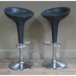 A pair of chromium plated and dark grey plastic adjustable kitchen stools