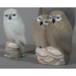 A pair of Royal Copenhagen owls resting on toadstools together with a single white owl perched on