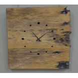 A rustic wooden clock drilled for the hours, battery movement, 60cm high,