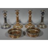 A pair of Victorian silver plated on copper coasters with gadrooned rims and fluted bellied bodies,