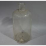 A large clear glass flagon, cylindrical with spigot aperture,