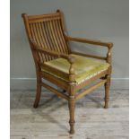 A 19th century walnut railback open armchair with velvet cushioned seat and on turned legs