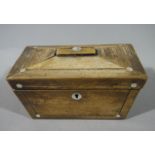 A Regency rosewood veneered sarcophagus shaped tea caddy strung with mother of pearl circles and