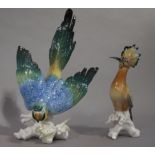 A large continental pottery figure of a parakeet alighting on a branch,