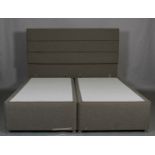 A Super King size double bed with box base mattress and padded grey head board,