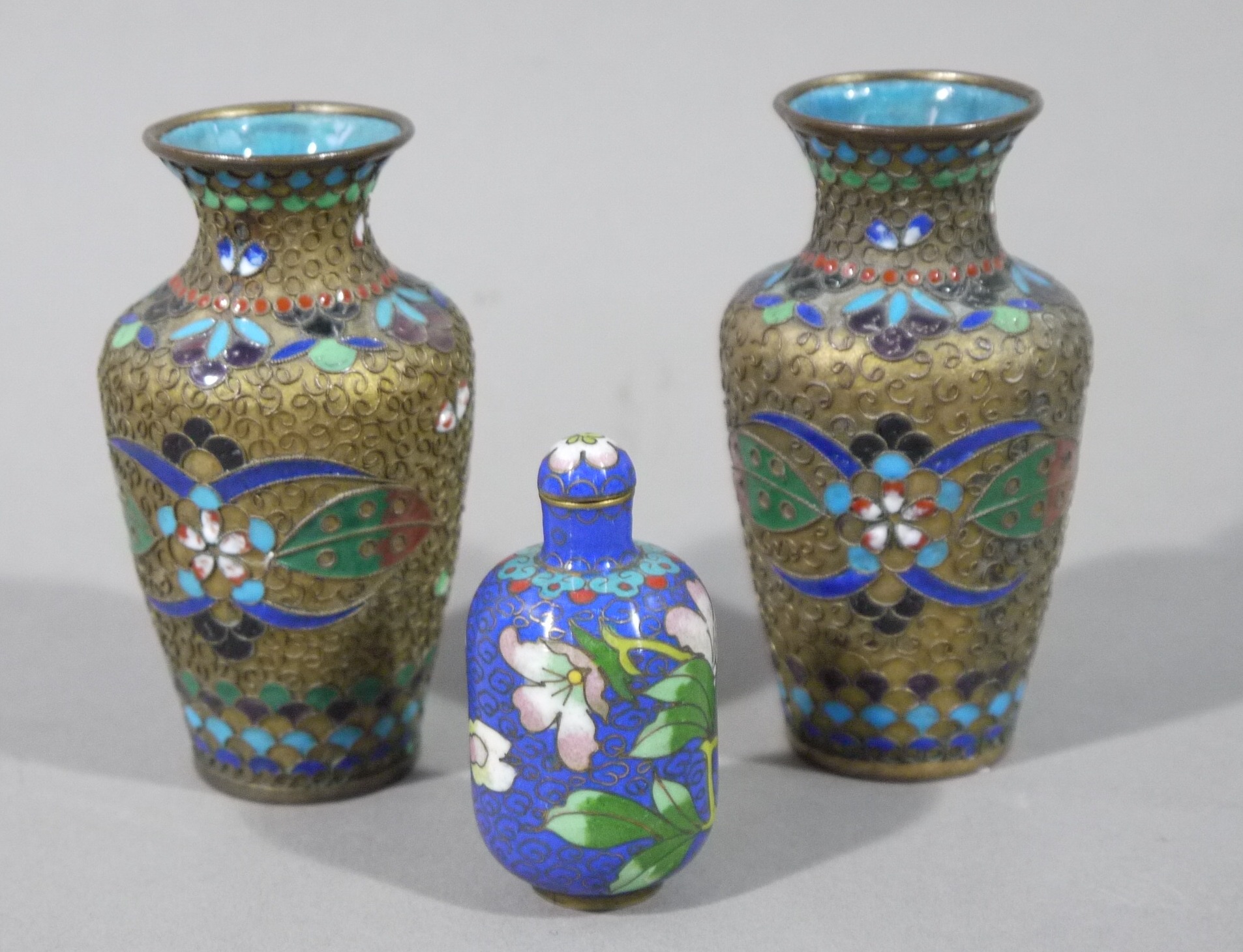 A pair of Chinese cloisonné vases, 9cm high together with a small cloisonné scent bottle,