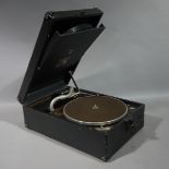 An HMV wind up gramophone contained within a black fabric covered rectangular case,