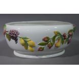 A large oval planter relief decorated with fruit and leafage to the cream glazed body,