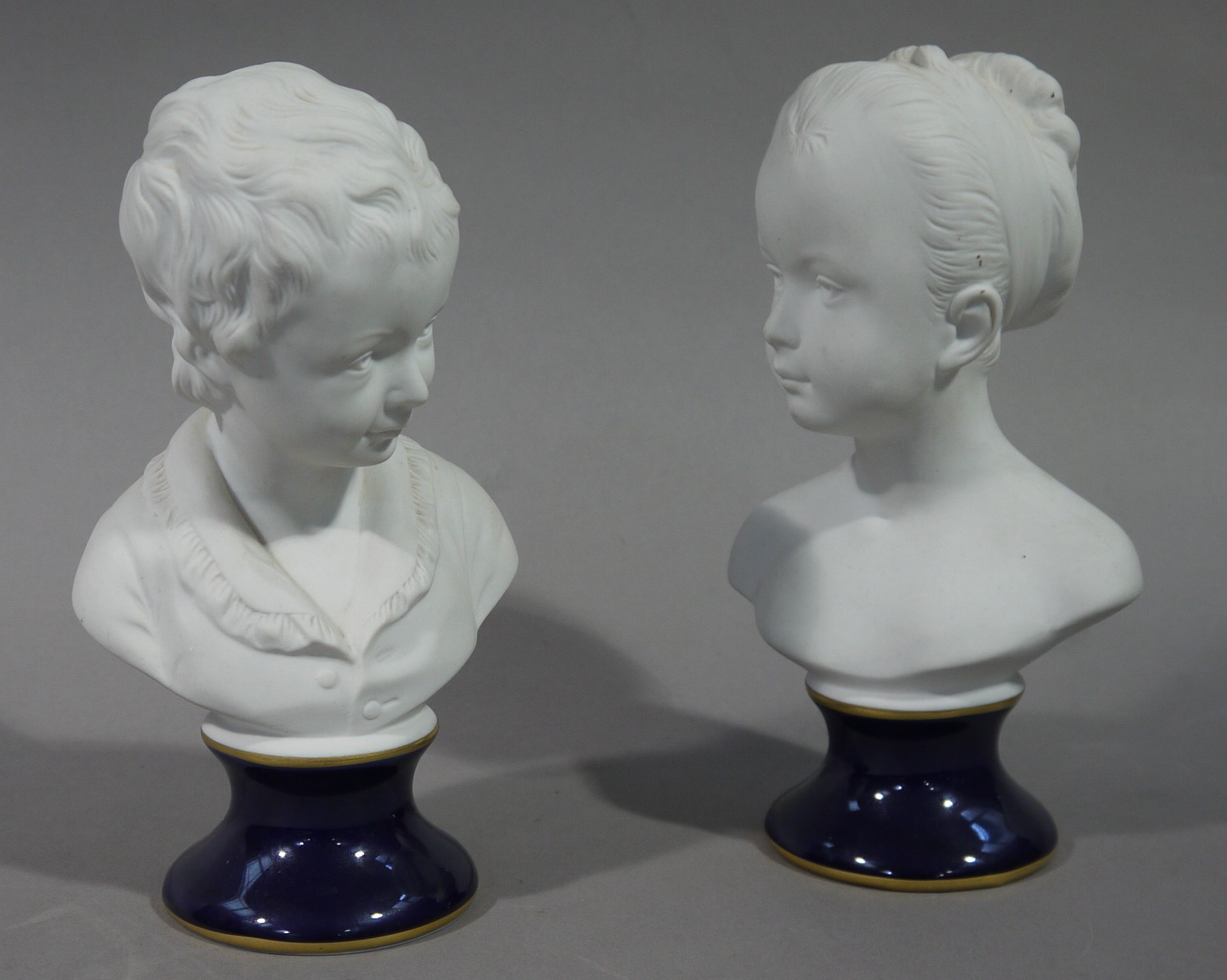 A pair of German porcelain bisque busts by Unterweissbach,