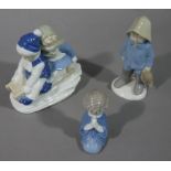 A continental pottery figure of children on a sledge,