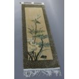 A modern sculpted woolen wall hanging of flowers and leafage within a geometric border, fringed,