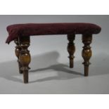 A Victorian oak miniature stool the upholstered rectangular top on turned legs,