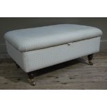 A reproduction ottoman, upholstered on mahogany, stained tuned legs,