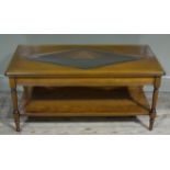 A reproduction cherry wood and glass coffee table the canted rectangular top inset with a bevelled