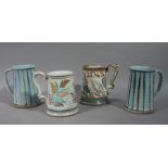 Two pairs of studio pottery tankards of blue striped and foliate painted decoration,