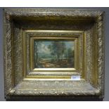 A reproduction oil painting of a figure in a landscape in elaborate gilt frame,