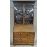 A 19th century mahogany bureau bookcase having a moulded and Greek key cornice above a rosette