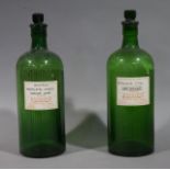 Two large green ribbed and moulded glass poison bottles with stoppers,