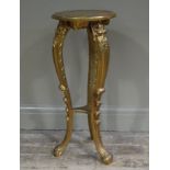 A gilt tripod stand having a circular top and on foliate moulded legs joined by an undertier