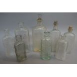 Five Boots the Chemists moulded clear glass flask bottles, 12.5cm to 16.