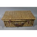 A wicker picnic hamper and contents