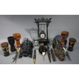 A quantity of tribal carvings, metal daggers with silver embossed sheaths, pottery goblets,