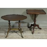 A reproduction mahogany shaped oval occasional table on turned supports,