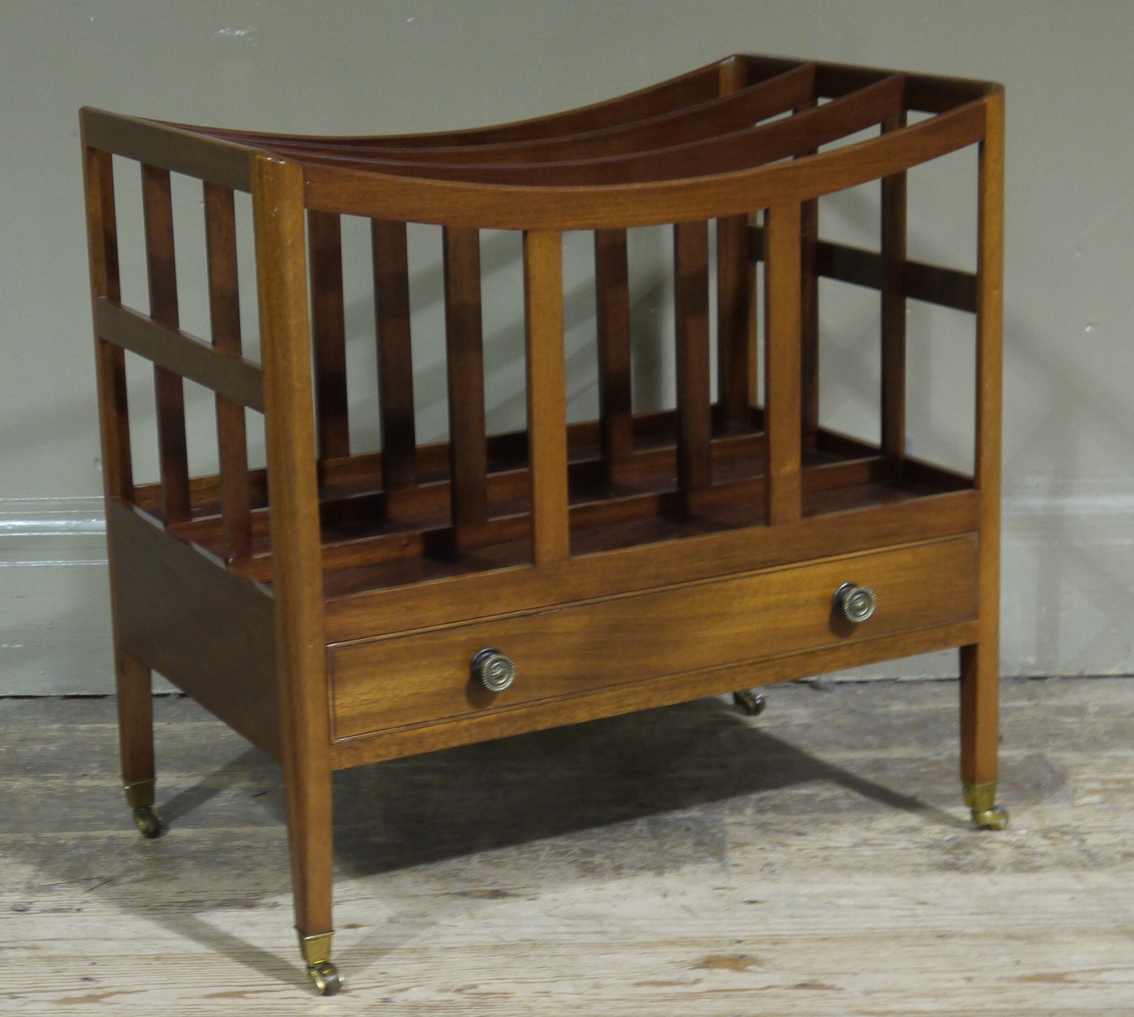 A reproduction mahogany Canterbury with drawer to base on square tapered legs with brass caps and