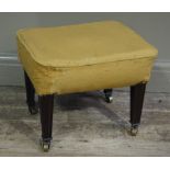 An early 20th century mahogany stool having a upholstered sprung seat and on moulded square tapered