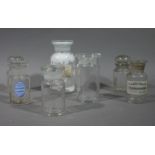 Five clear glass pharmacy bottles with disc stoppers various sizes from 17cm to 11cm high together