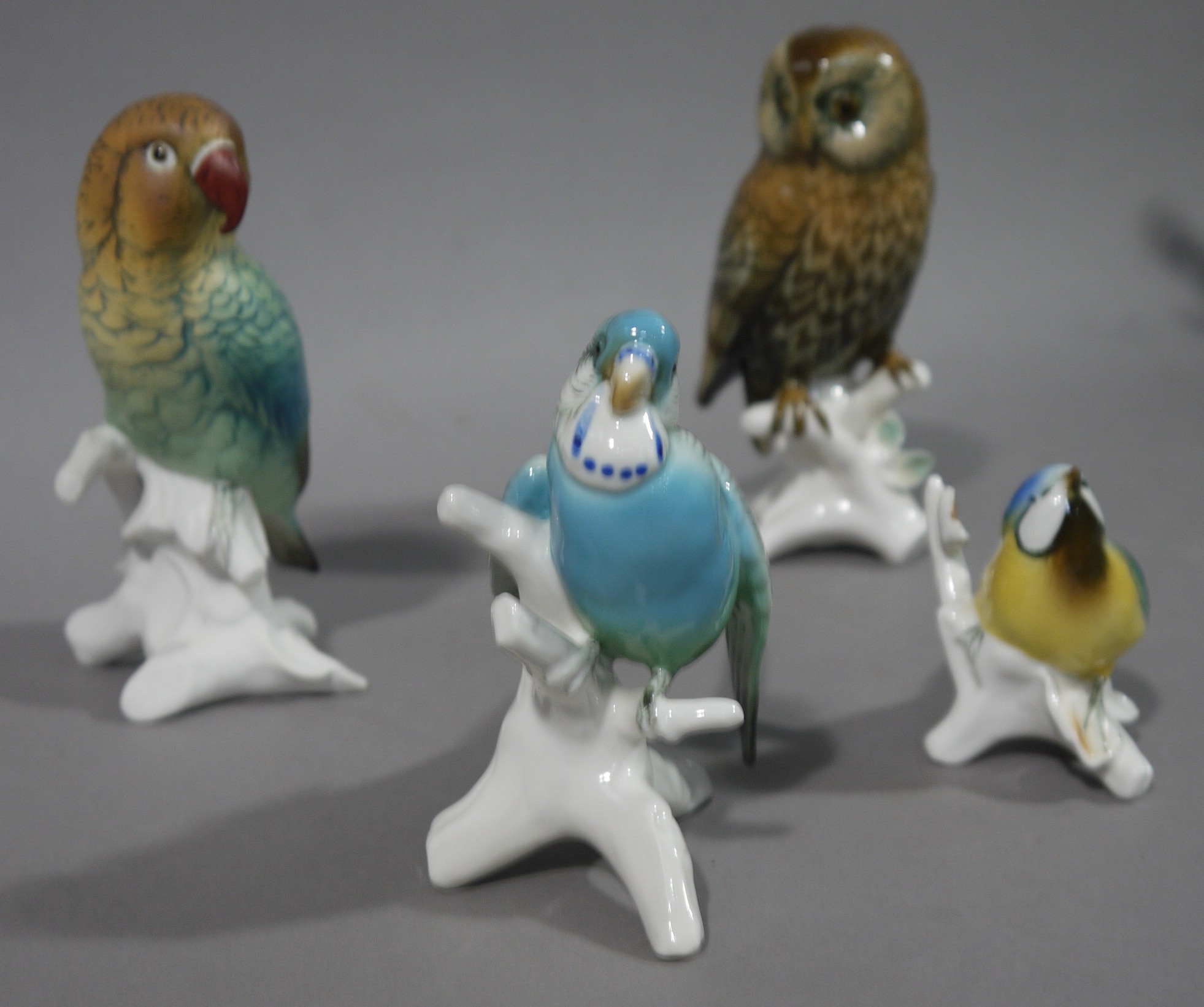 Four continental pottery figures of birds with blue printed mark to underside,