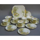 A Shelley Daffodil Time part tea service each piece transfer printed comprising five cups,