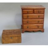 A late 19th century mahogany apprentice chest the rectangular top above two short and three long