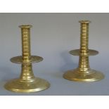 A pair of late 17th century style brass candlesticks with ribbed tapered stems,