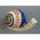 A Royal Crown Derby paperweight modelled as a snail, printed in red date code XLV111, 13cm wide,