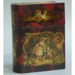 An Italian papier mache box modelled as a book printed with panels of courtiers and winged amorini