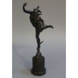 A bronze figure of Mercury after Giambologna face mask and circular plinth stand,