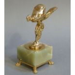 A reproduction gilt metal model of Spirit of Ecstasy on square green onyx plinth with gilt metal