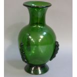 A green glass baluster vase with everted neck and spreading circular foot the body applied with